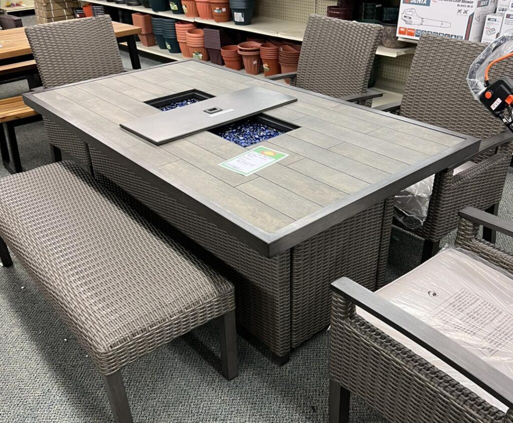 An outdoor table and chair set with a built-in fireplace